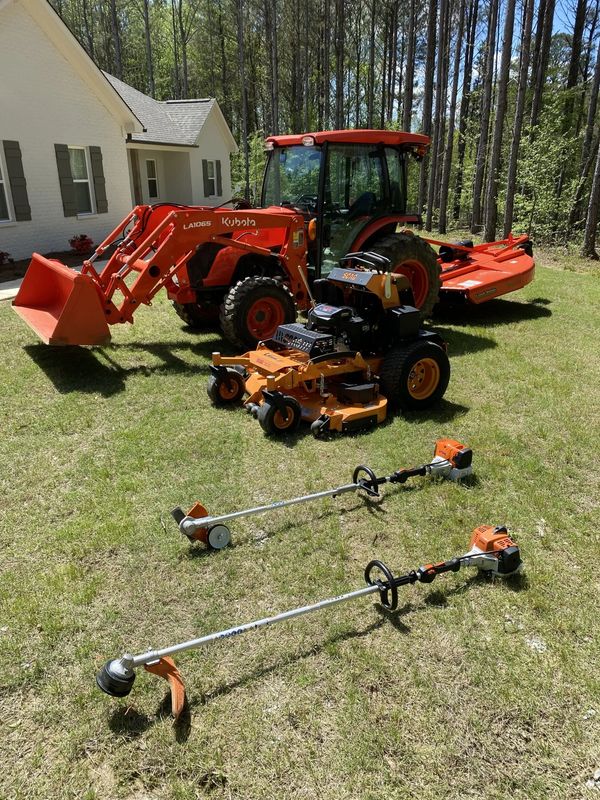 My Kubota tractor, land pride bush hog, behind Scag Mower and Stihl trimmer in front of house 38655