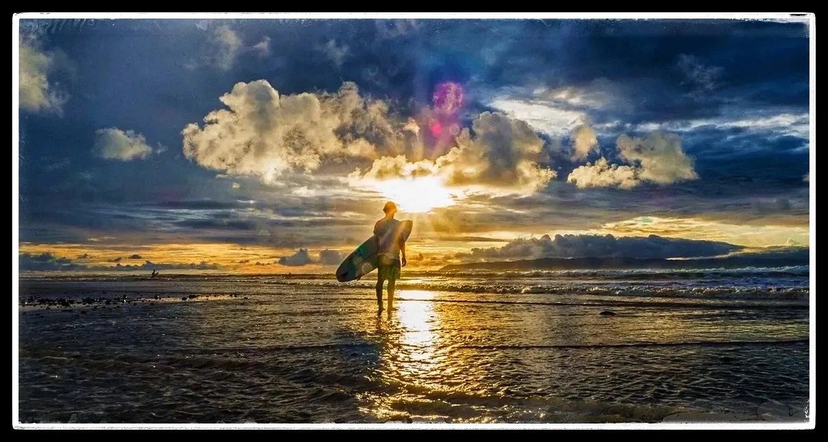 A surfer getting out of the water in Pavones