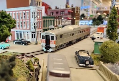 Model train in a miniature town setup.