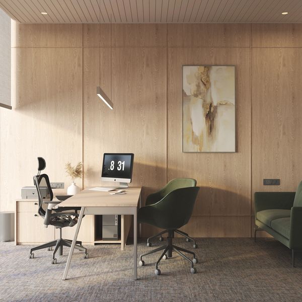 Modern office with wooden walls, ergonomic chairs, and a computer on the desk.