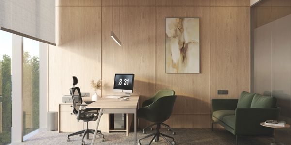 Modern office with wooden panel walls, green seating, and natural light.