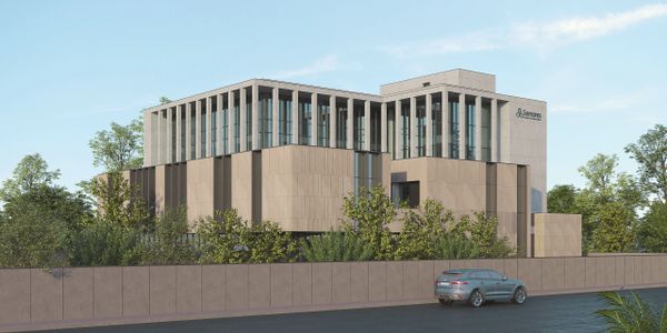 Modern office building with glass windows and beige exterior walls.