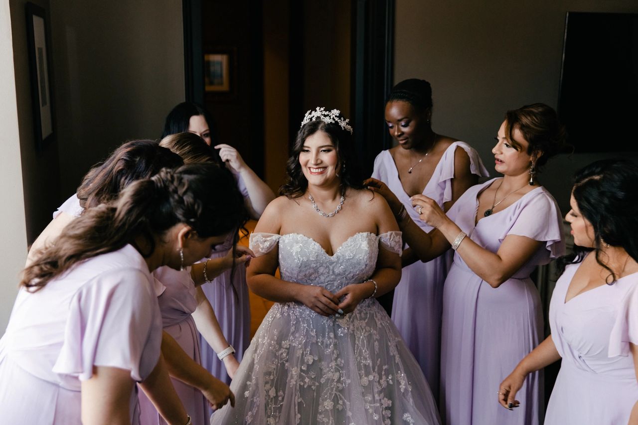 Bride and bridesmaid getting ready for wedding day in Houston Texas