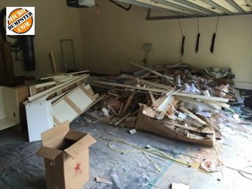 A pile of construction debris inside a garage ready to be loaded and hauled in Niles, IL