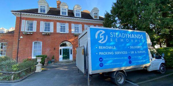 Home removal van parked outside flats