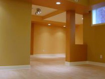Empty room with orange walls and light floor.