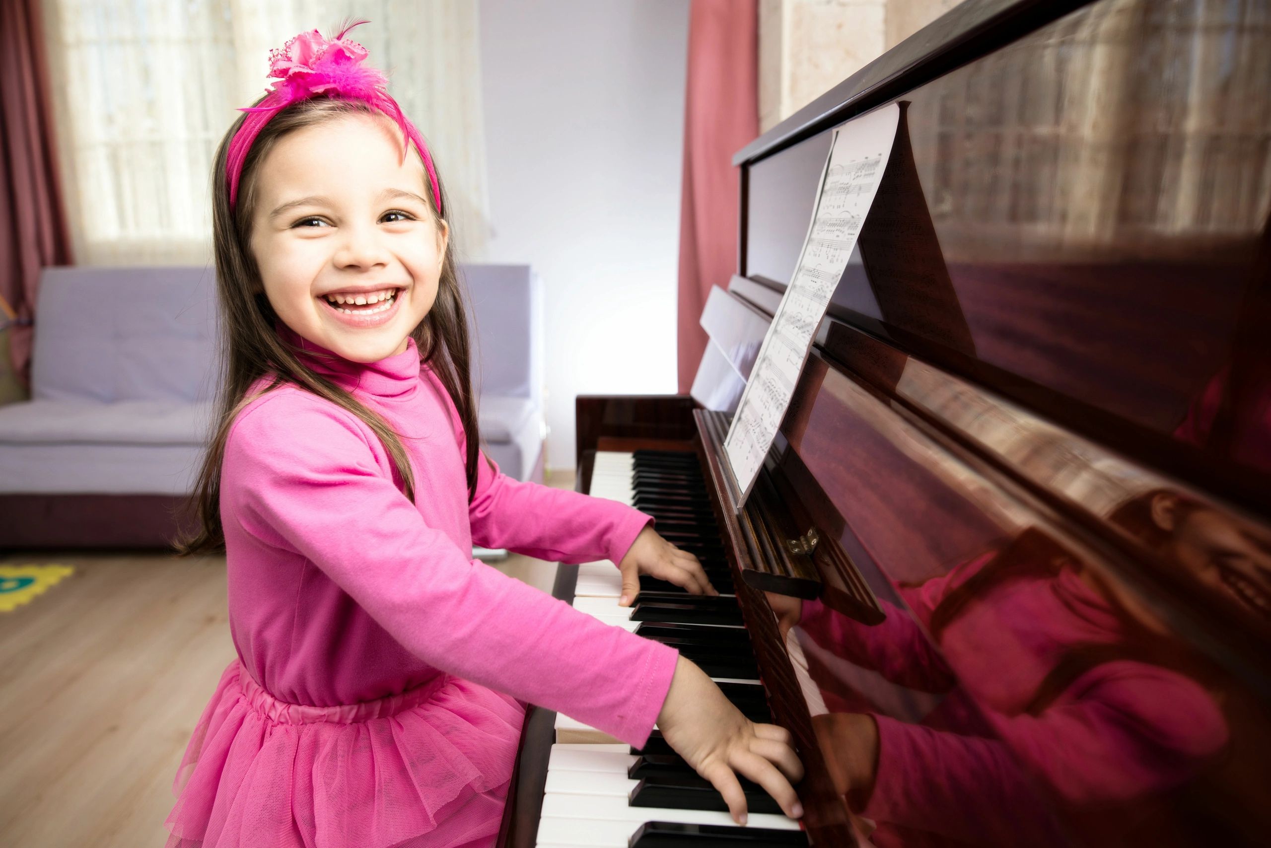 girl smiling at the piano