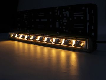 A sleek LED light bar emitting warm yellow light in a dark setting.