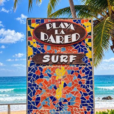 Colorful mosaic sign for Playa La Pared Surf at the beach.