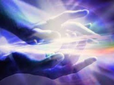 Hands surrounded by mystical light beams.