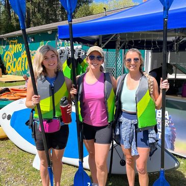 3 women with kayak paddles