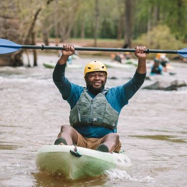 Kayaker holding paddle above head