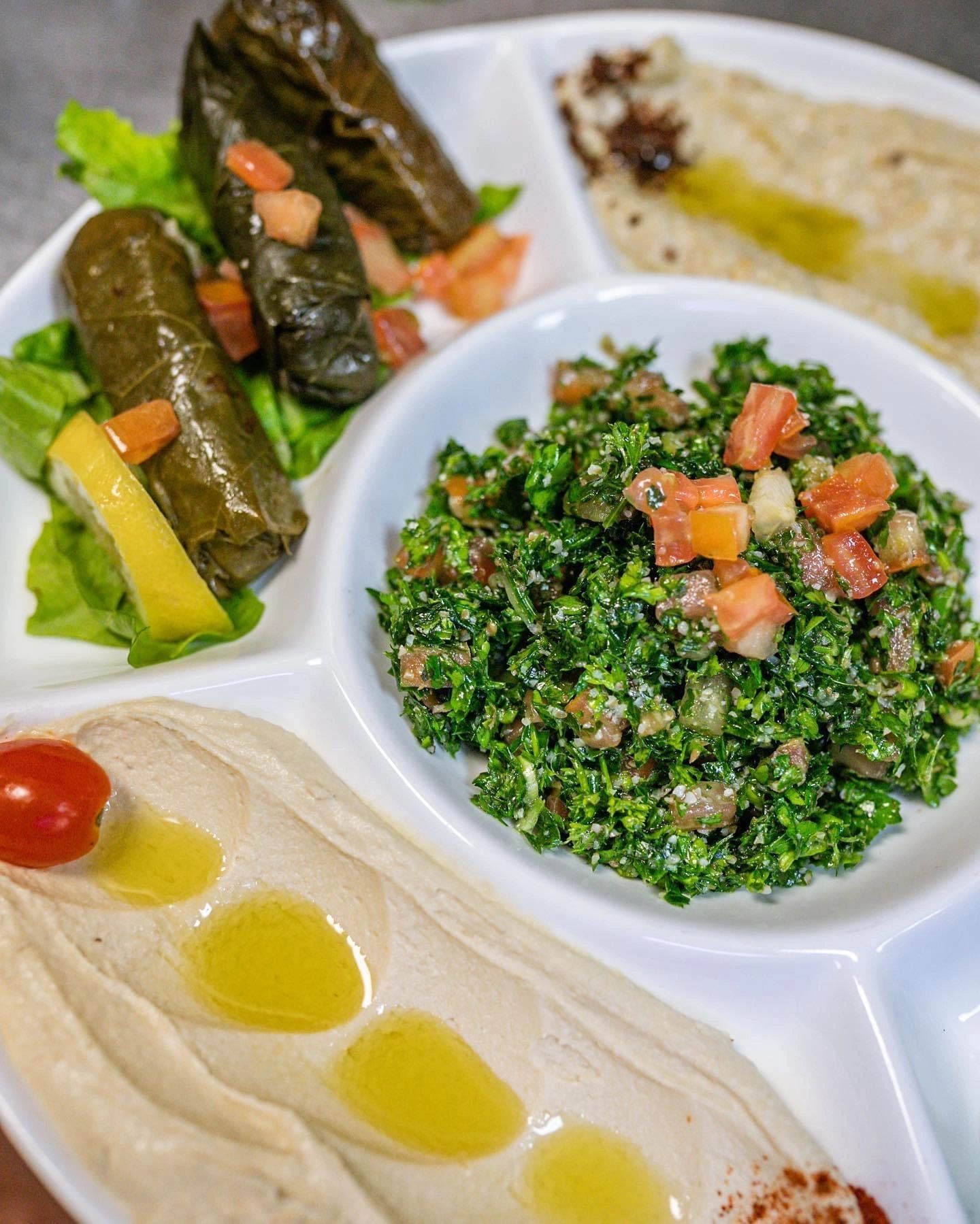 Cold Mezza with tabbouleh, hummus, baba ghanouj, grape leaves, moujadara and pita