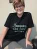 Female wearing a black t-shirt that says all bodies are good bodies. 
