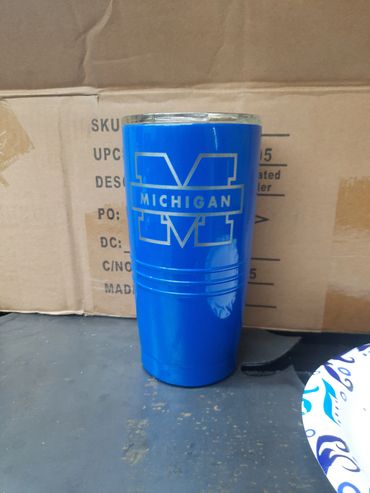 Blue Michigan-themed cup placed on a cardboard box.