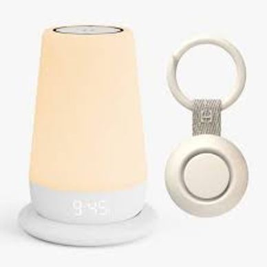 A modern bedside lamp with digital clock and a keychain holder.