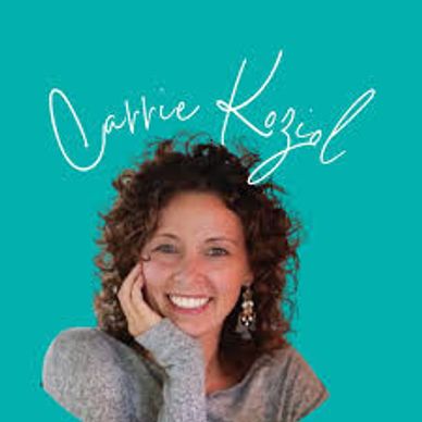 Smiling woman with curly hair against turquoise background.