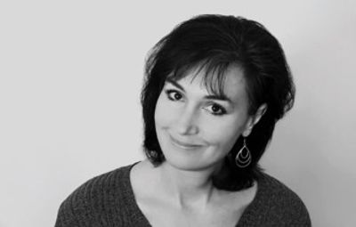 Black and white portrait of a woman smiling.
