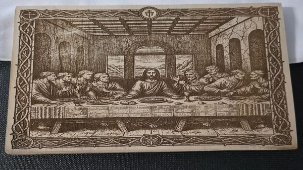 Wooden engraving of The Last Supper depicting Jesus and his disciples.