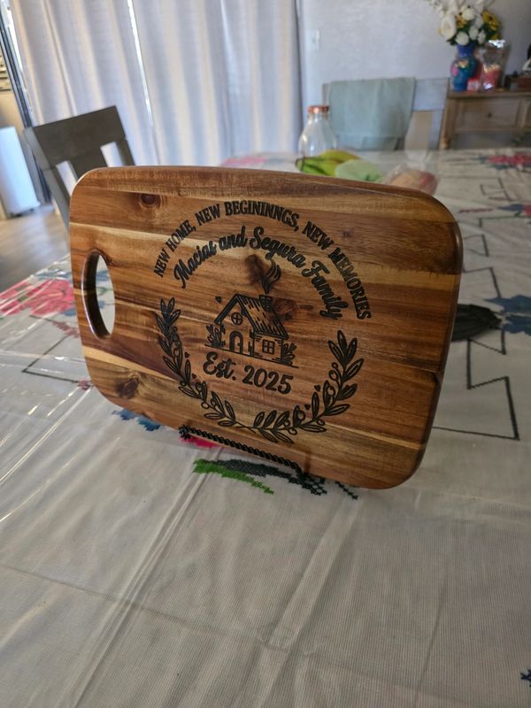 Personalized wooden cutting board celebrating a new home and family.