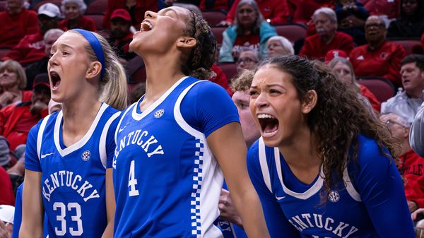 Kentucky's Josie Gilvin (33), Lexi Blue (4), and Gabby Brooks (11) cheer a three-point shot.