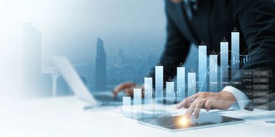 Businessman analyzing digital financial growth charts on a tablet.