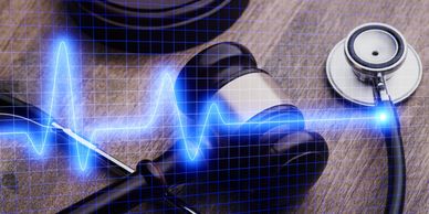 A gavel and stethoscope connected by a glowing heartbeat line.