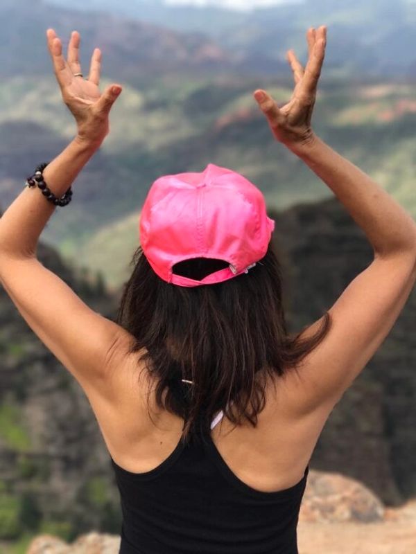 A woman standing at a cliff.