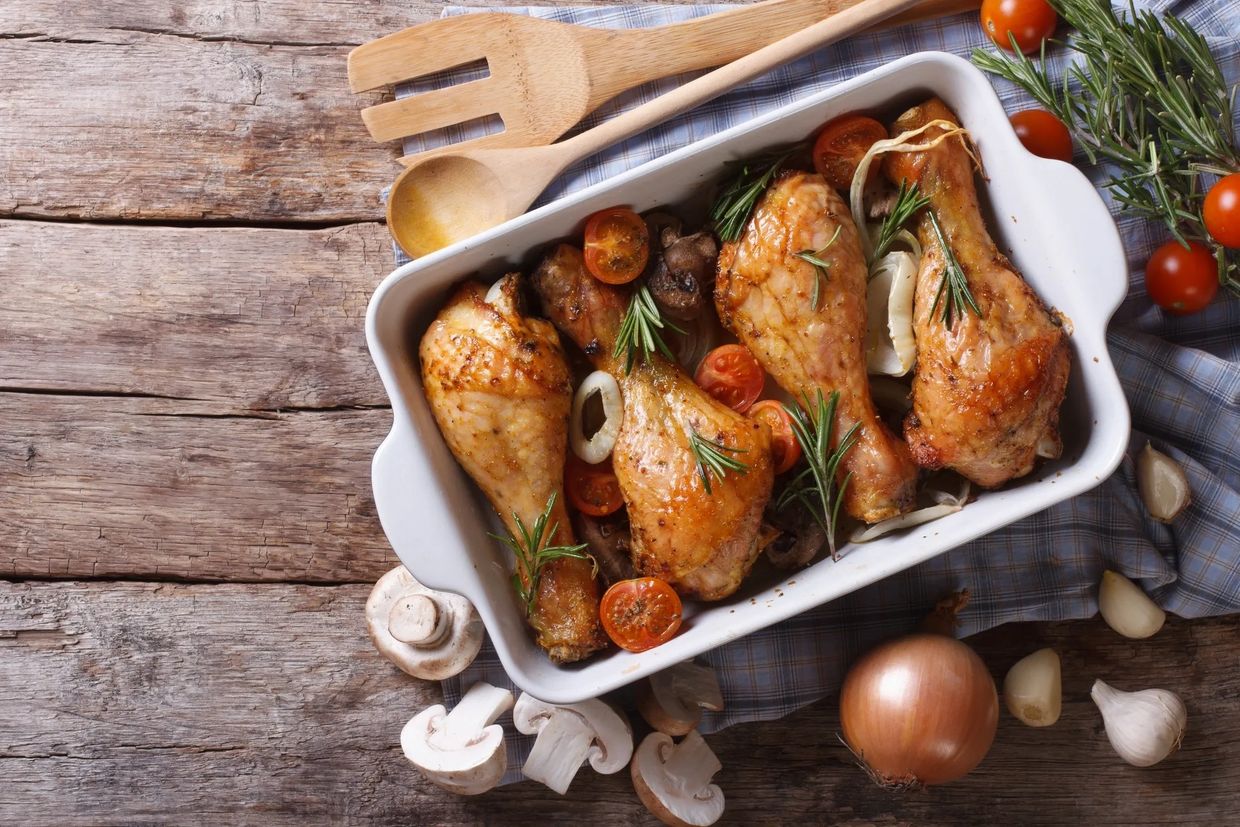 Roasted chicken drumsticks with mushrooms, tomatoes, and rosemary.