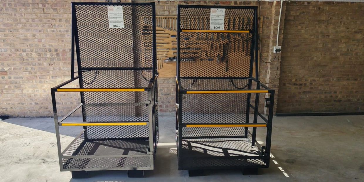 Two black metal cages with mesh sides and yellow strips.
