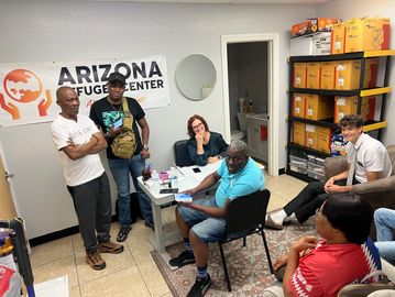 A group meeting at Arizona Refugee Center with diverse participants.