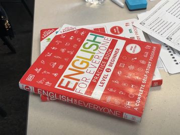 Two English language practice books for level C1-B2 on a desk.