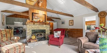 Cozy living room with fireplace and rustic decor.