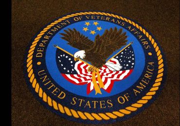 Seal of the U.S. Department of Veterans Affairs with an eagle and flags.