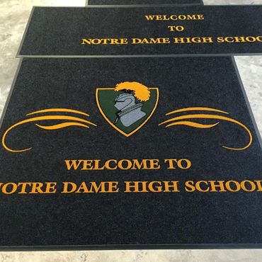 Welcome mats for Notre Dame High School with a knight emblem.