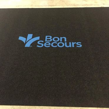 Black mat with blue Bon Secours logo and text.
