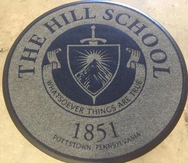 Round mat with The Hill School emblem and founding year 1851.