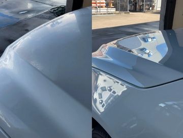 Close-up of a car's hood with a smooth, glossy white paint finish.