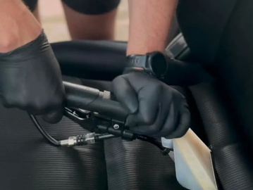 Professional shampoo extraction being performed on a fabric car seat