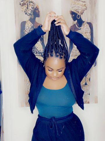Woman lifting her braided hair up.