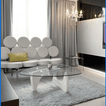 Modern living room with unique circular sofa and glass coffee table.