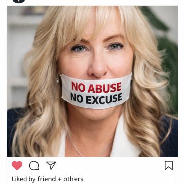 Woman with tape on mouth reading 'No Abuse No Excuse' advocating against abuse.
