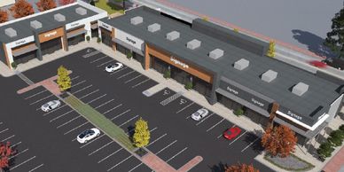 A shopping center with multiple storefronts and parking spaces.