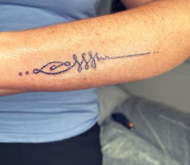 Photo of a fine line tattoo for strength. 