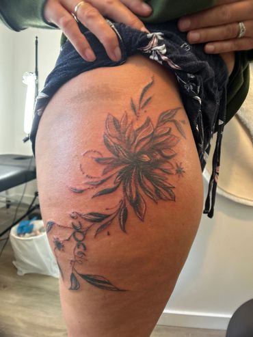 A photo of a floral fine line tattoo 