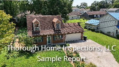 Aerial view of a suburban house with a garage.