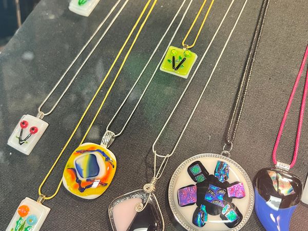 Jewelry made from fused glass in our craft classes up for sale at a local shop