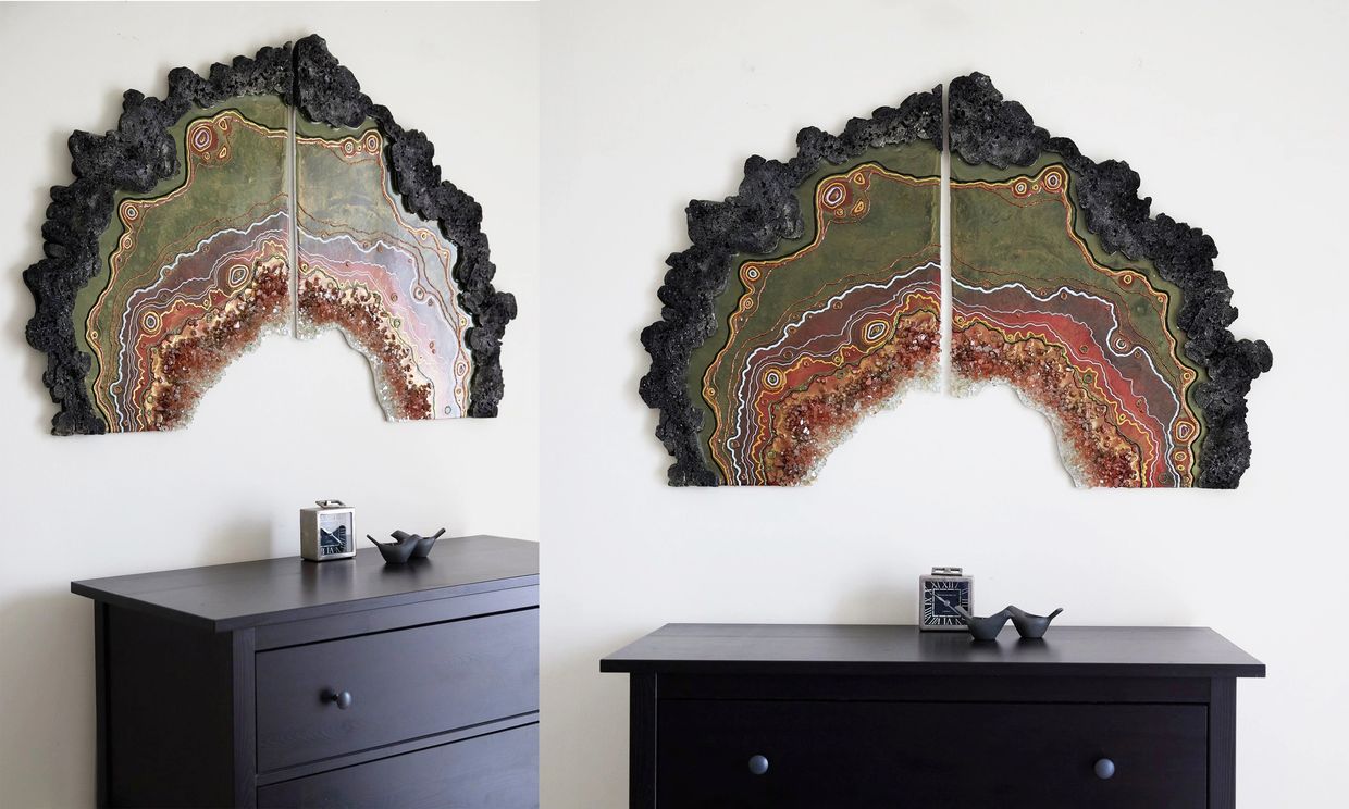 Two-panel geode-inspired wall art above a black dresser with a clock and decorative bird figurines.