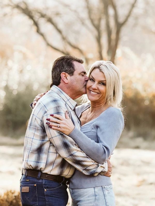 Owner with husband together hugging