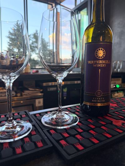 Two wine glasses and a bottle of Watermill Winery Estate Red Blend.